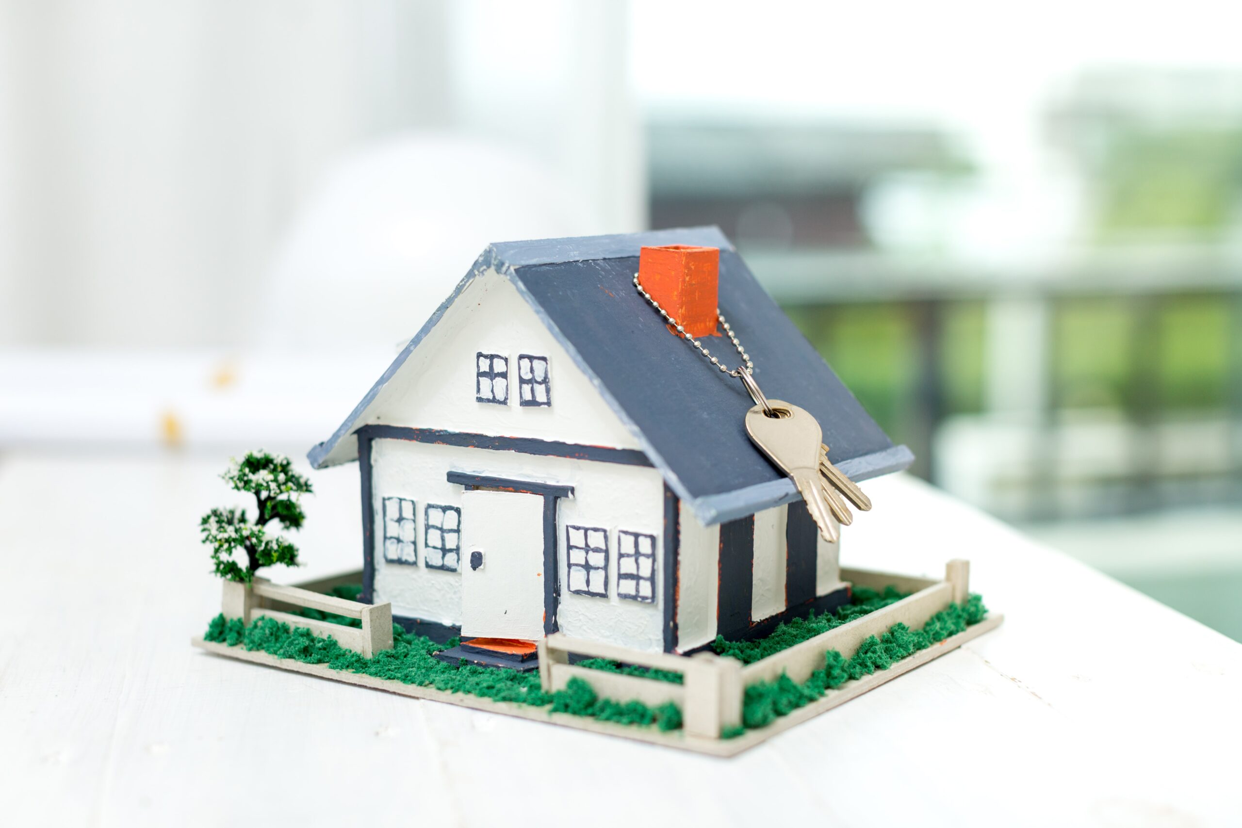 real-estate-with-house-model-keys-min